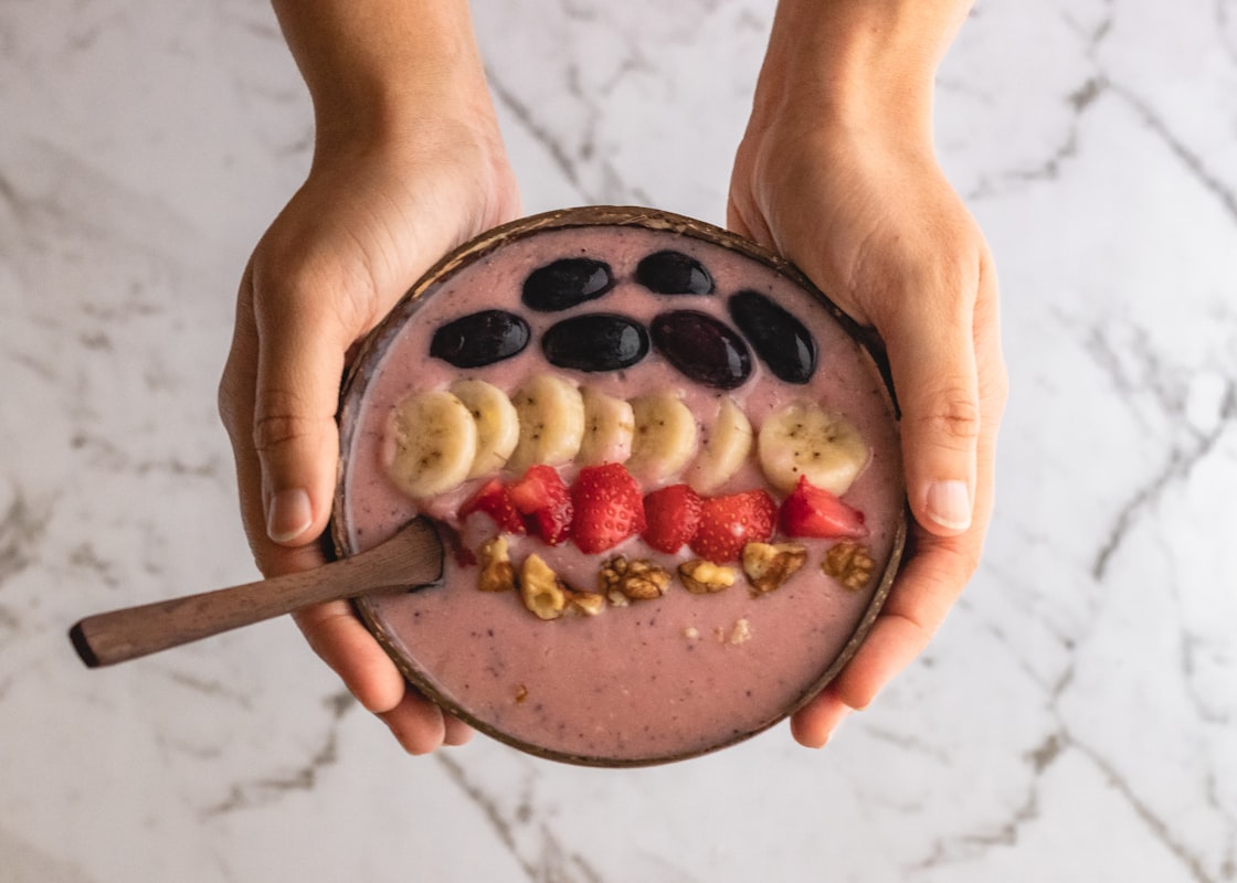 Green smoothie bowl with granola and fresh berries